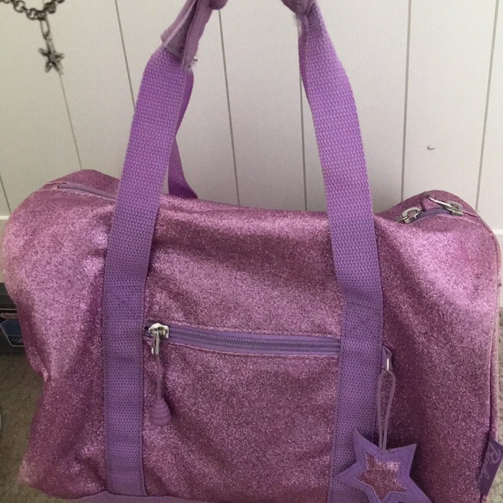purple sparkly mini duffel bag .